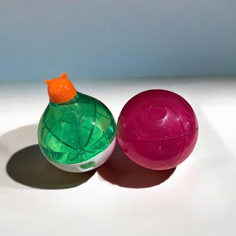 Two Green & Pink Spinning Treat Capsule Dispensers for Cats